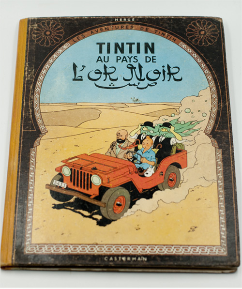 Album Tintin au pays de l’Or noir après restauration, avec dos consolidé, couverture stabilisée et bords restaurés.